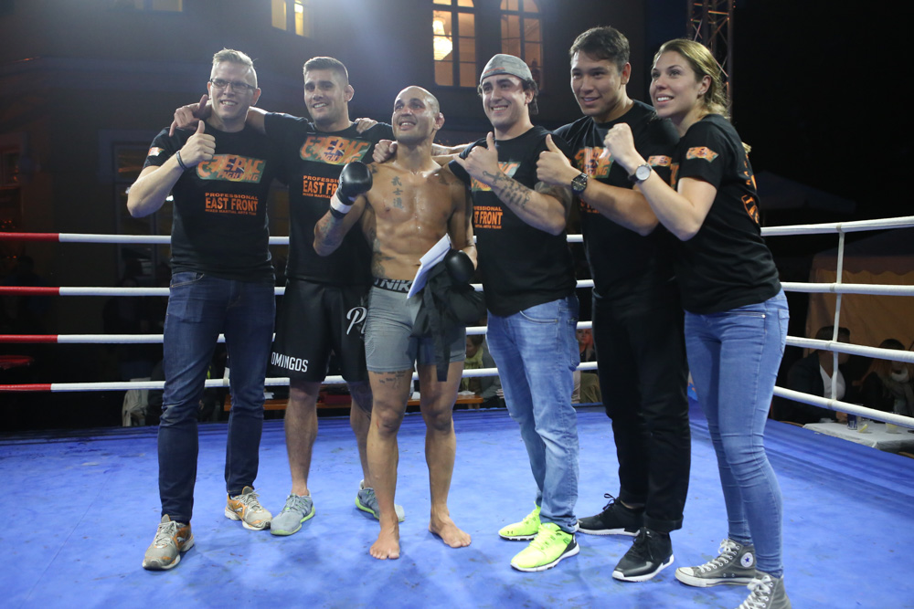 Macedo and his team celebrating victory after a tough fight.